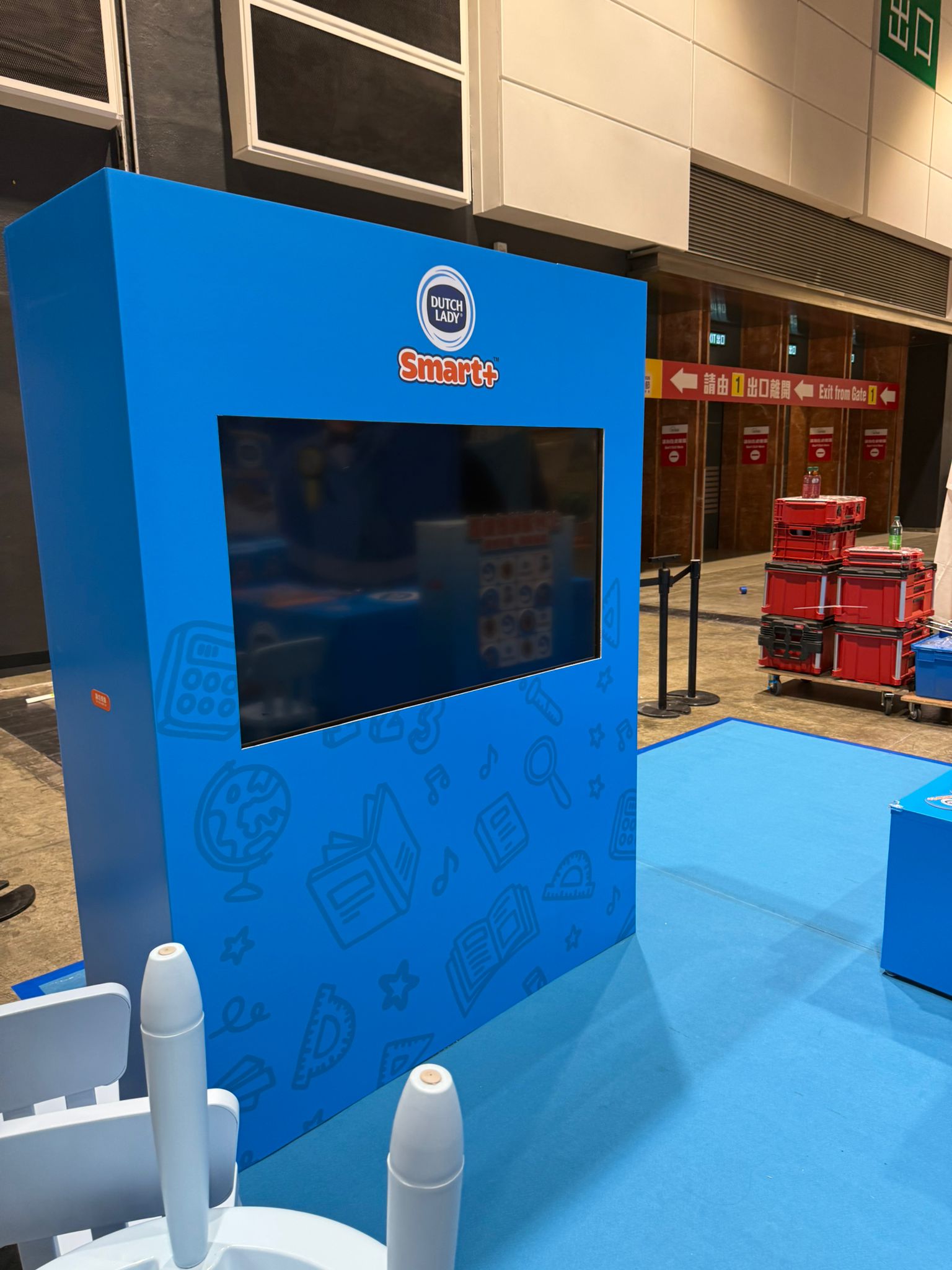 TV mounted in a freestanding blue display stand at an exhibition.