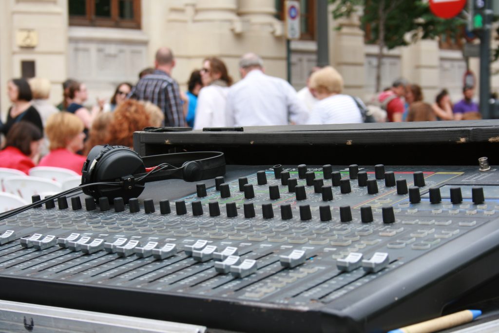 Close Up Sound Mixer Against Crowd Media Flow Studio SG Comparing Sound System Rental Pricing