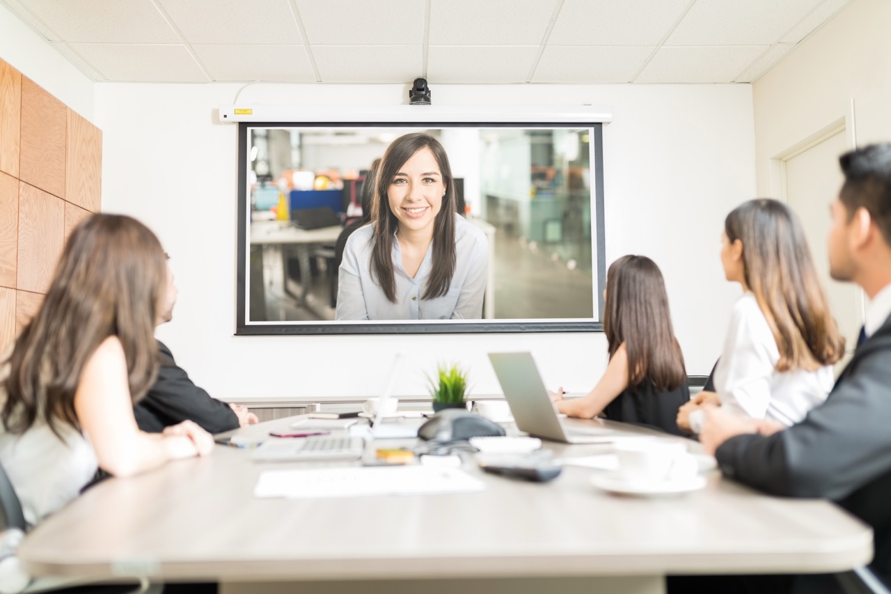 Corporate team viewing a presentation on a projector screen